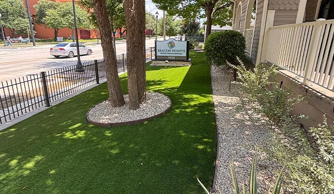 Artificial grass installed in a landscaped front yard