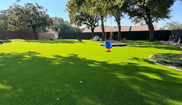 Large backyard covered with artificial grass