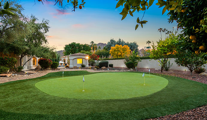 Beautiful residential backyard with artificial golf putting green